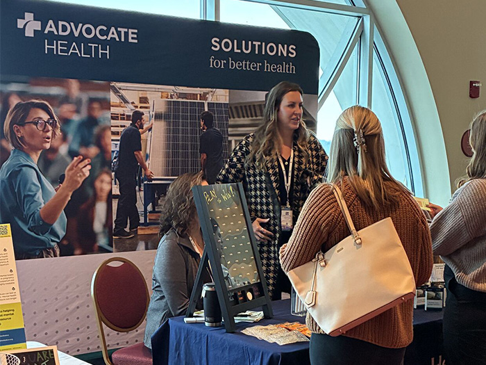 Woman talking to another woman at a sponsor booth