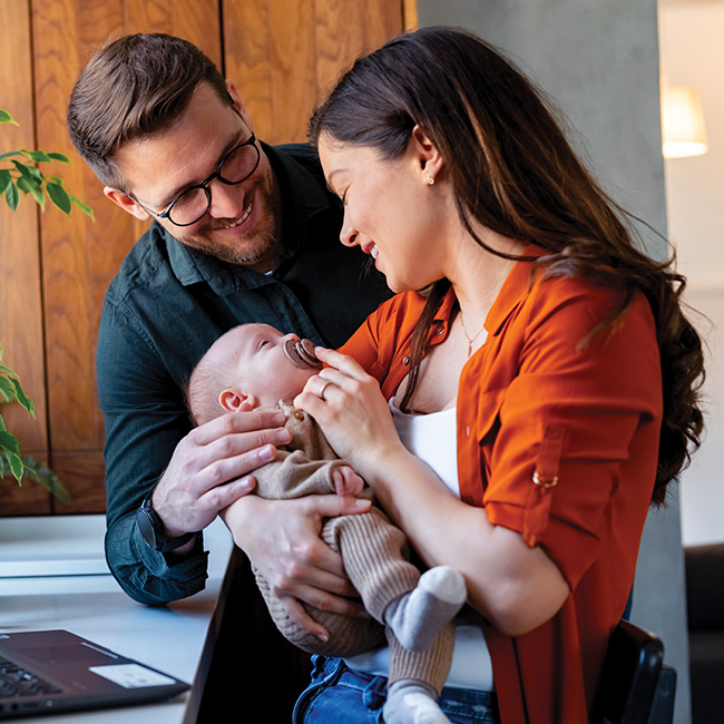 Young couple holding a baby