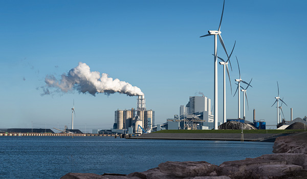A windfarm and a smokestack