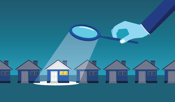 Illustration of a row of houses and a hand holding a magnifying glass over one of them