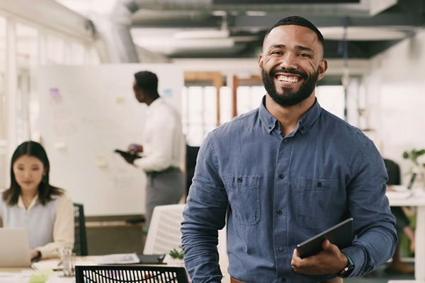 Portrait, smile and designer man with tablet in office, creative workplace or coworking in startup company